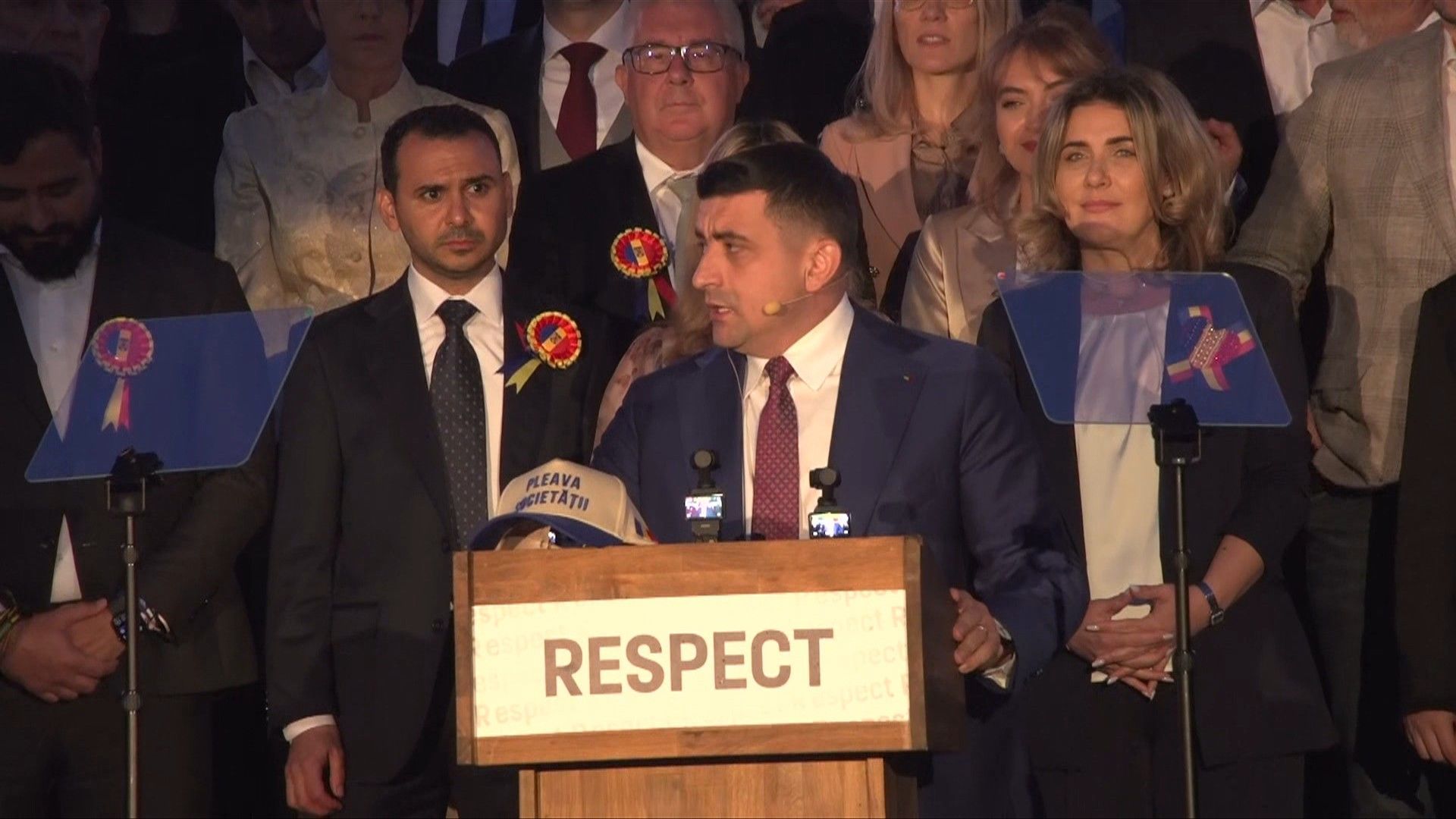 Romania's George Simion arrives for his speech after the election
