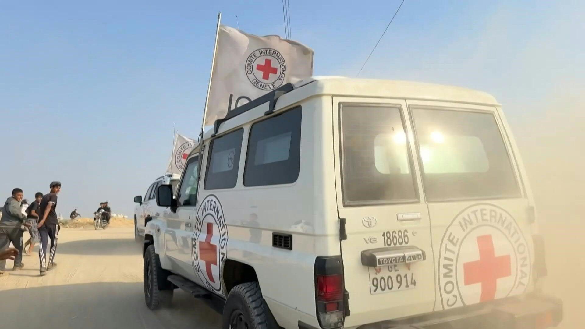 Red Cross vehicles transport remains of officer killed in 2014 Gaza war