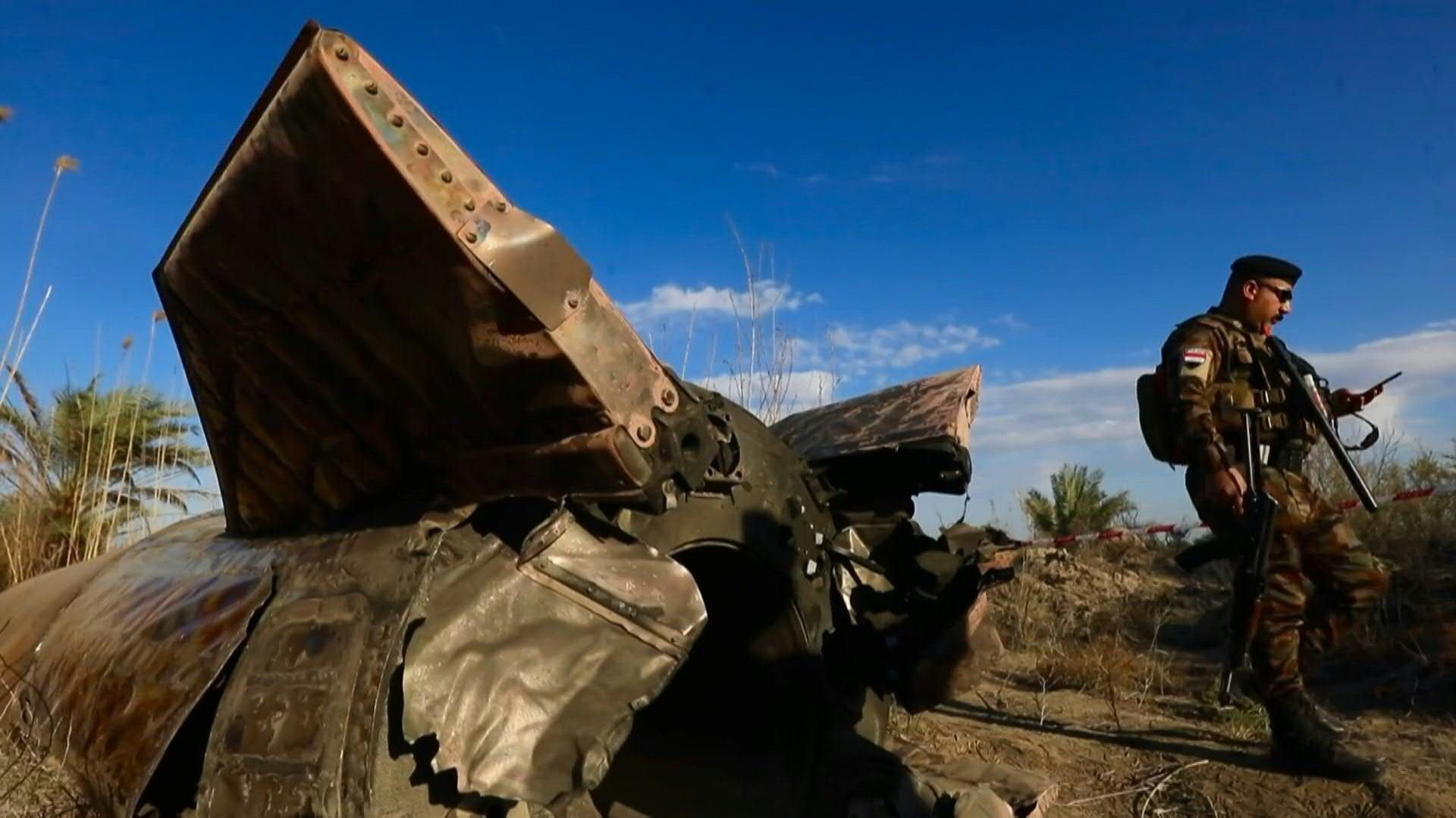Video: Iraqi officers inspect missile debris that landed in central Iraq
