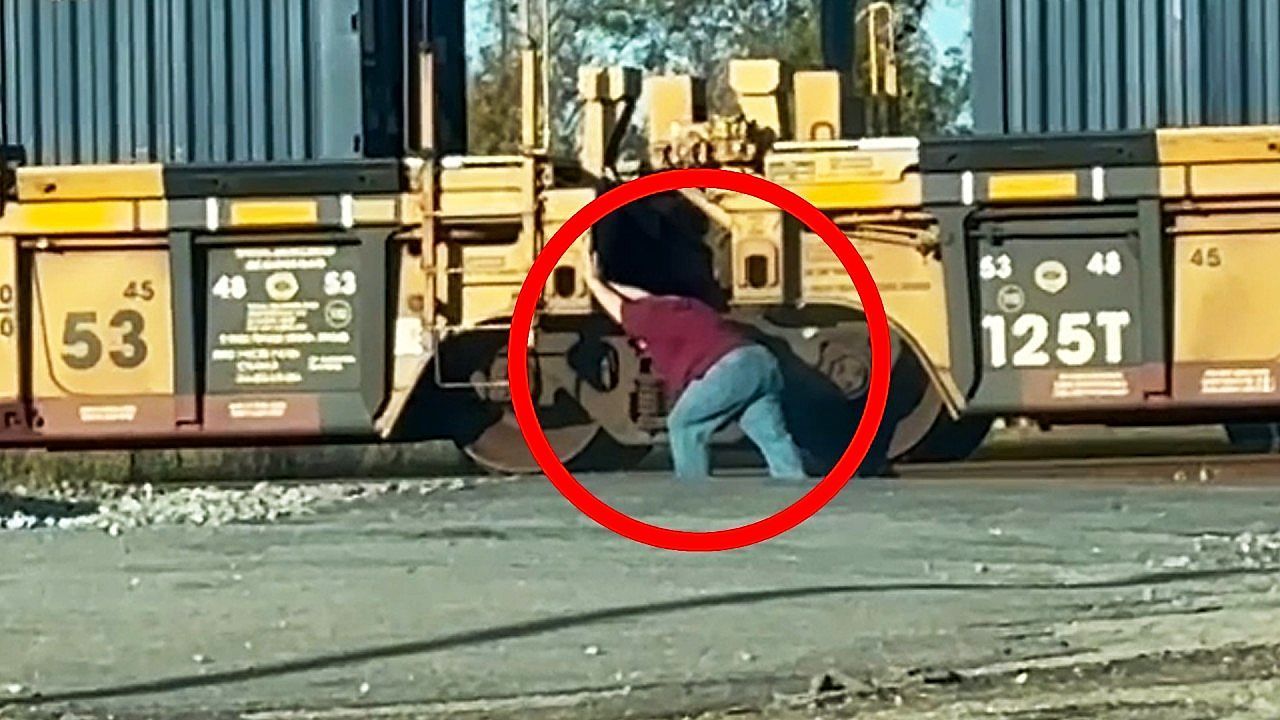 Impatient-wife-gets-out-of-car-and-tries-to-help-a-stopped-train