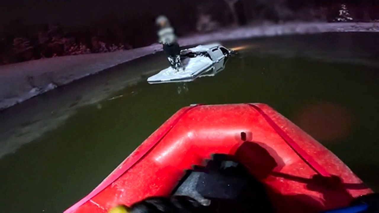 Video: Firefighters rescue driver stranded in icy pond in North Carolina